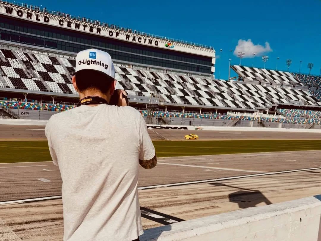 Joe R. Wells photographing the yellow No. 89 from pit wall at Daytona