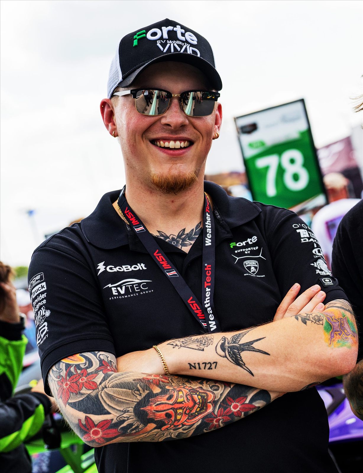 Joe R. Wells smiling in the paddock at an IMSA race